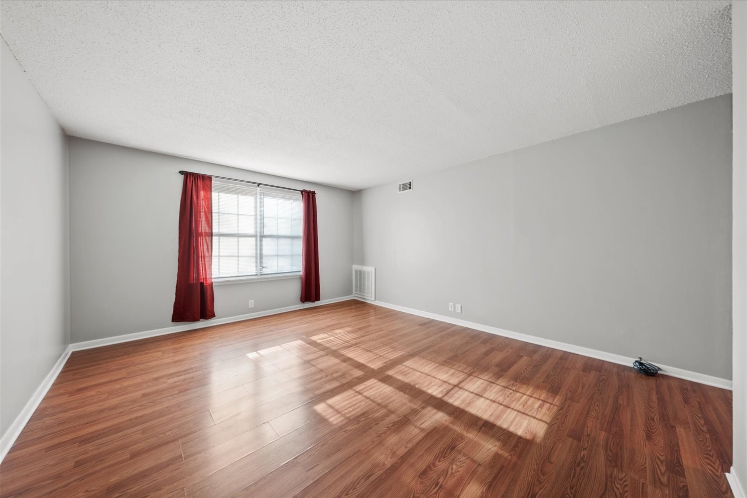 441 Harding Place, Unit A12 Nashville, TN 37211 - Photo 4 of 21 a view of an empty room with a window and wooden floor