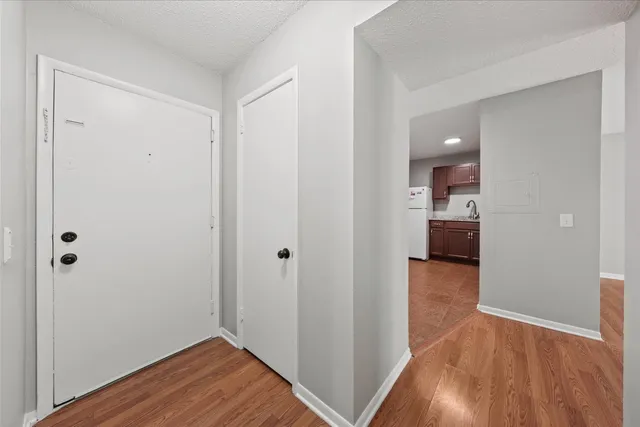 a view of a room with wooden floor