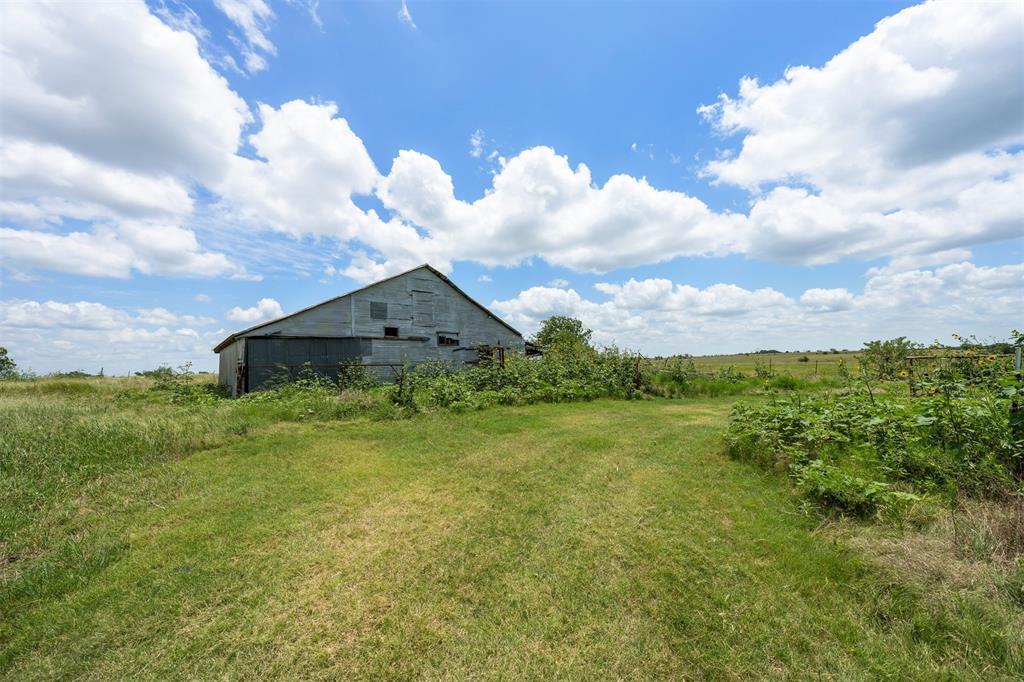 6450 Farm To Market Road 217 Valley Mills, TX 76689 - Photo 15 of 16 View of green lawn featuring a barn, an outdoor structure, and a rural view
