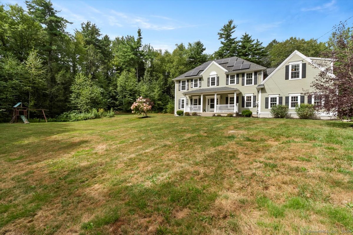 a front view of a house with a garden