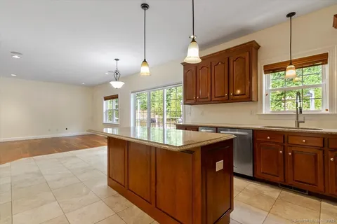 a kitchen with stainless steel appliances granite countertop a sink and a window