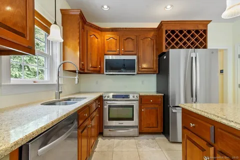 a kitchen with stainless steel appliances granite countertop a sink and a microwave
