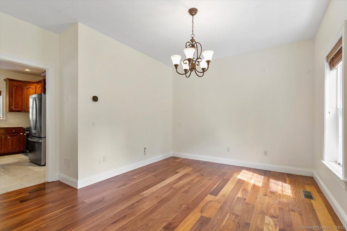 151 Losaw Road Winchester, CT 06021 - Photo 17 of 40 a view of empty room with wooden floor and window