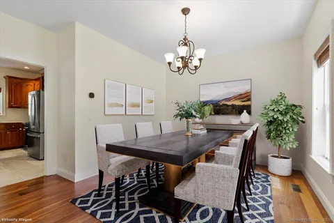 a view of a dining room with furniture wooden floor and a chandelier