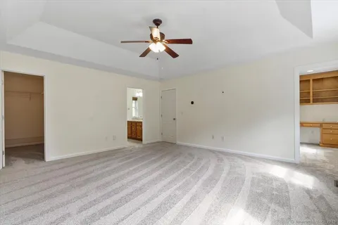 a view of a livingroom with a ceiling fan and window