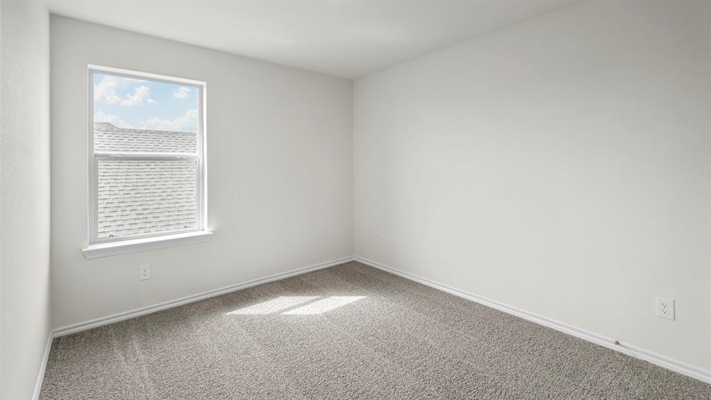 216 Pheasant Run Road Terrell, TX 75160 - Photo 19 of 37 Neutral wall color with plush carpet flooring and natural light from a window