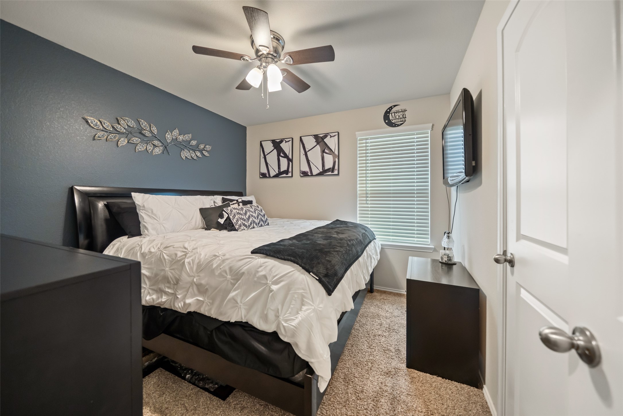 22806 Spruce Summit Trail Spring, TX 77373 - Photo 18 of 31 a bedroom with a large bed and a chandelier