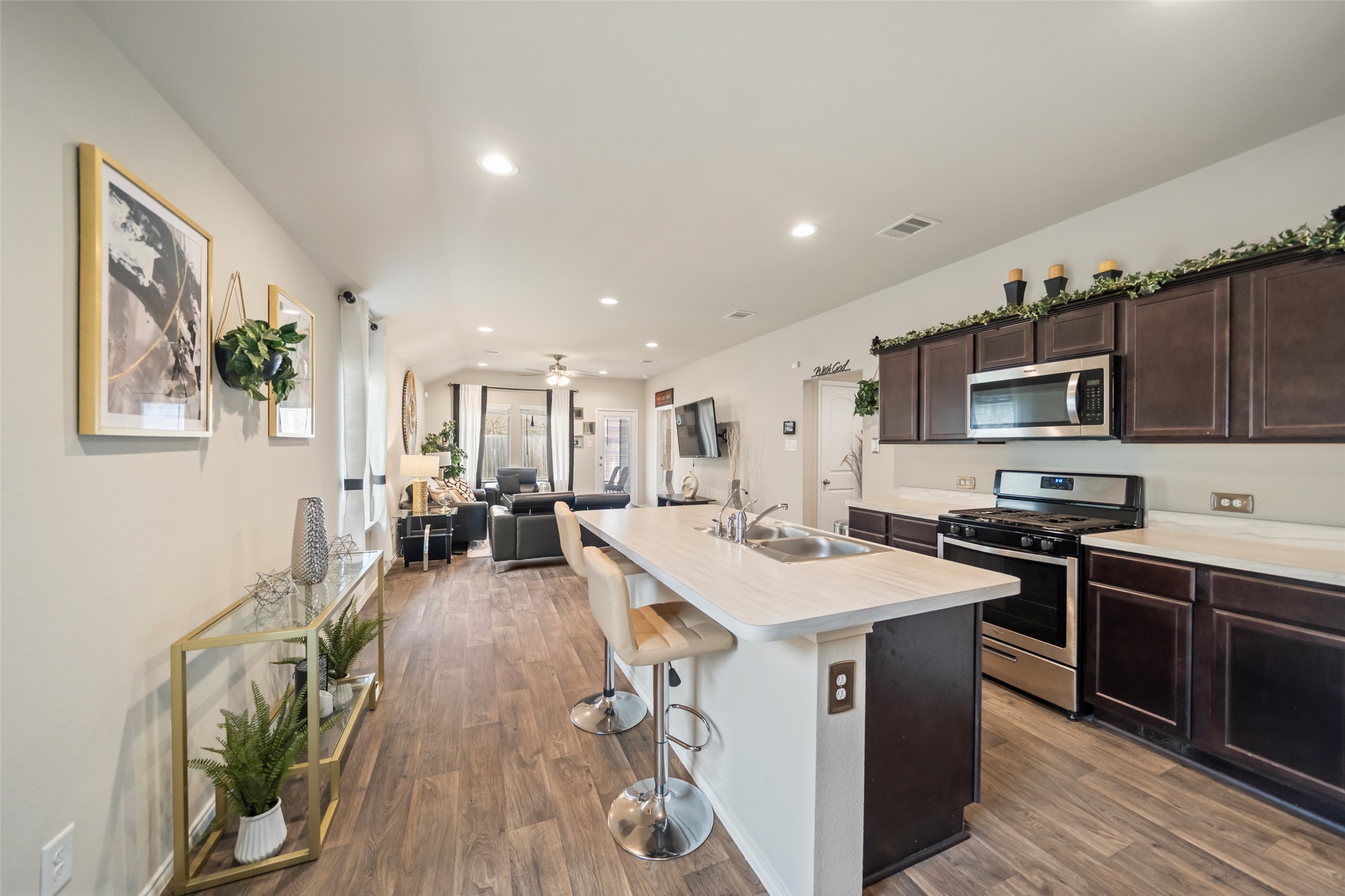 22806 Spruce Summit Trail Spring, TX 77373 - Photo 4 of 31 a kitchen with stainless steel appliances a sink a stove a refrigerator cabinets and a dining table