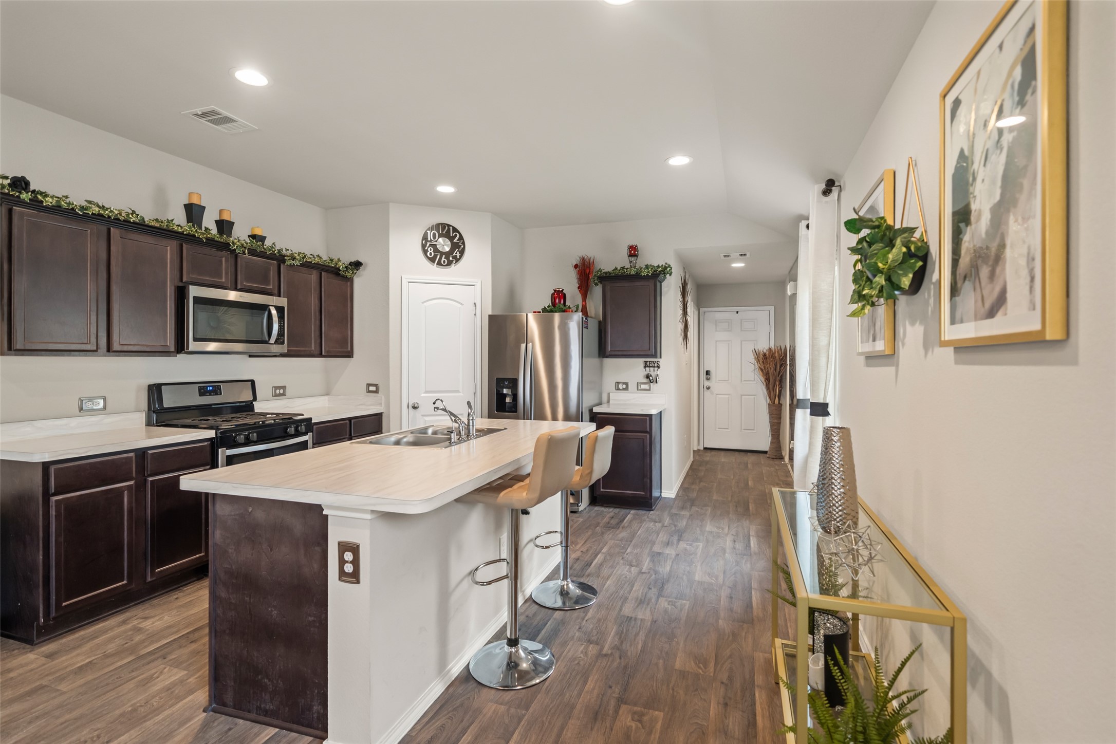 22806 Spruce Summit Trail Spring, TX 77373 - Photo 5 of 31 a kitchen with stainless steel appliances granite countertop a sink stove refrigerator and a wooden floor