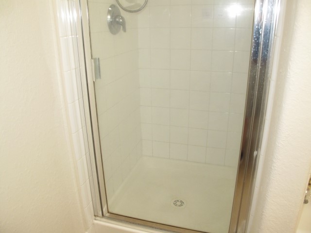 3142 Rendezvous Court Spring, TX 77373 - Photo 21 of 30 a bathroom with a glass shower door
