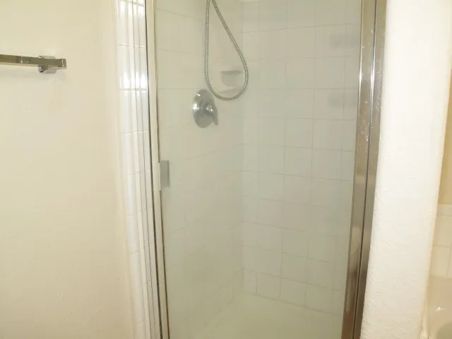 a bathroom with a glass shower door