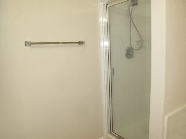 a bathroom with a glass shower door