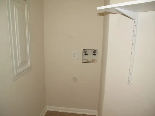 a view of backyard and wooden fence