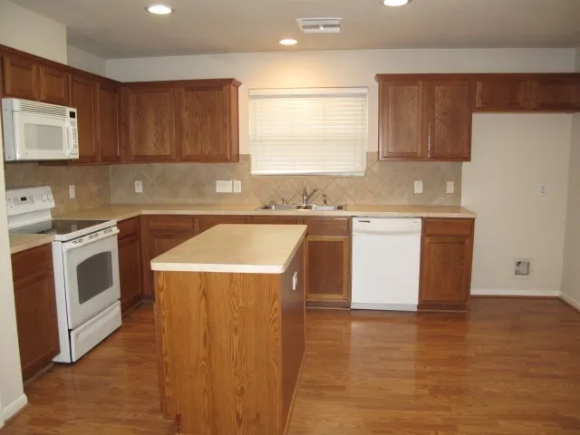 a view of washer and dryer with wooden floor
