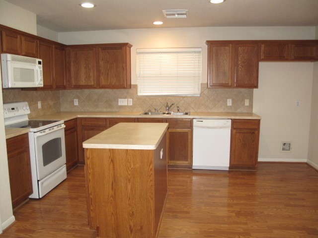 3142 Rendezvous Court Spring, TX 77373 - Photo 5 of 30 a kitchen with a sink a stove and cabinets