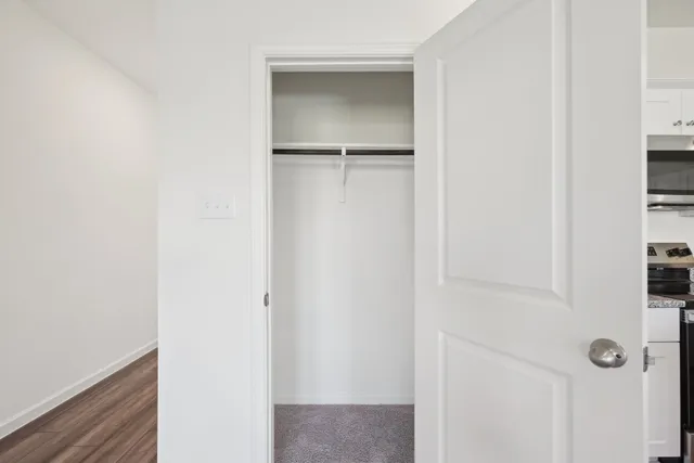 a view of walk in closet with empty racks