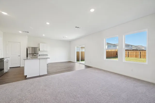a view of kitchen and hall with wooden floor