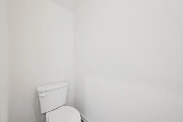 a bathroom with a double vanity sink toilet and shower