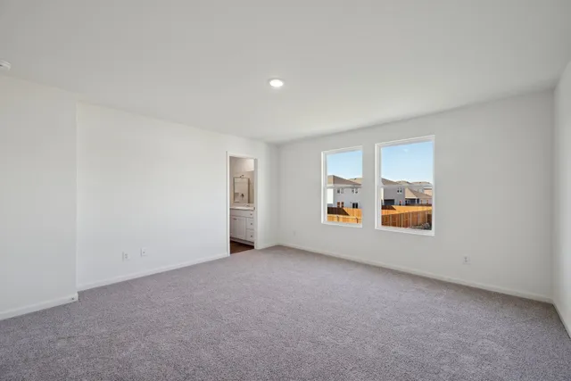 a bedroom with a balcony a bed and dresser with mirror