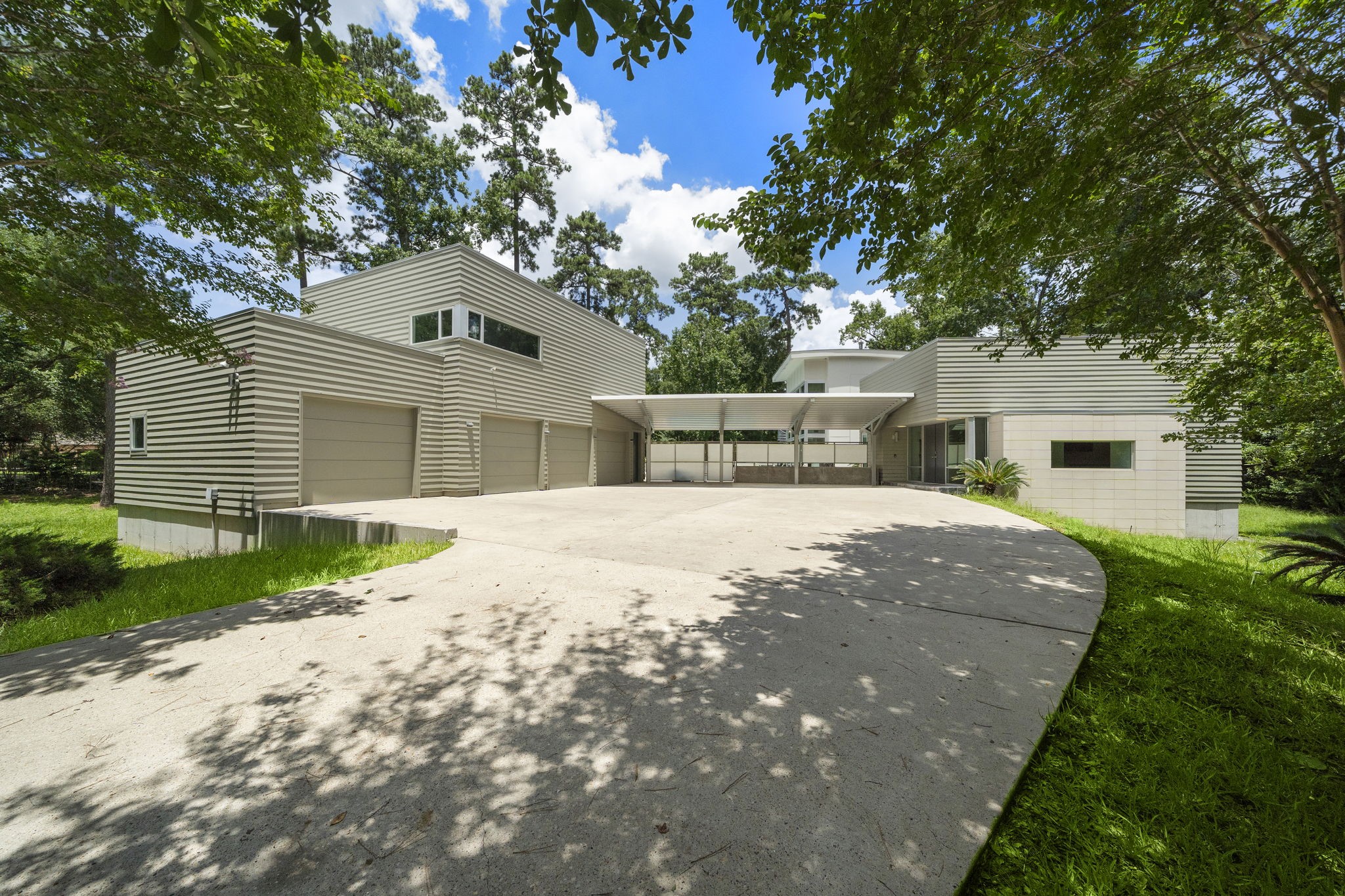 118 Angel Leaf Road The Woodlands, TX 77380 - Photo 45 of 50 Drive-up view of the striking modern architecture framed by nature.
