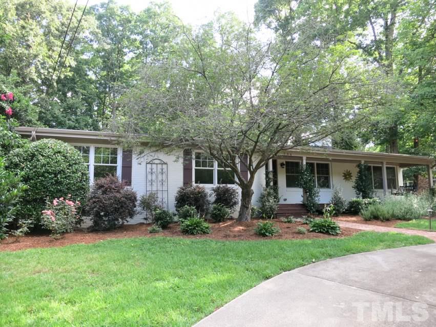 704 Currituck Drive Raleigh, NC 27609 - Photo 1 of 25 a view of a house with backyard sitting area and garden