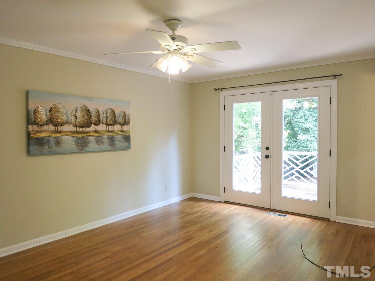 704 Currituck Drive Raleigh, NC 27609 - Photo 13 of 25 an empty room with wooden floor and window