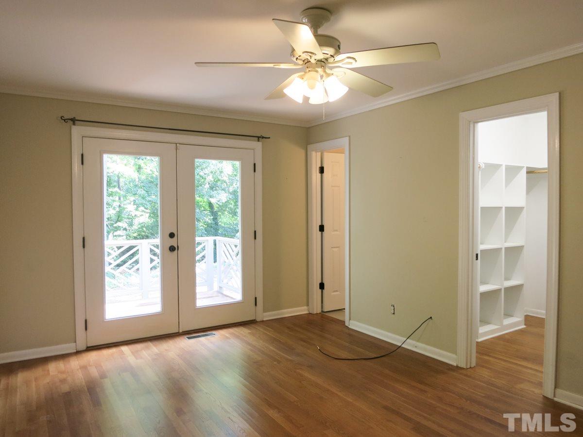 704 Currituck Drive Raleigh, NC 27609 - Photo 14 of 25 a view of an empty room with wooden floor and a window