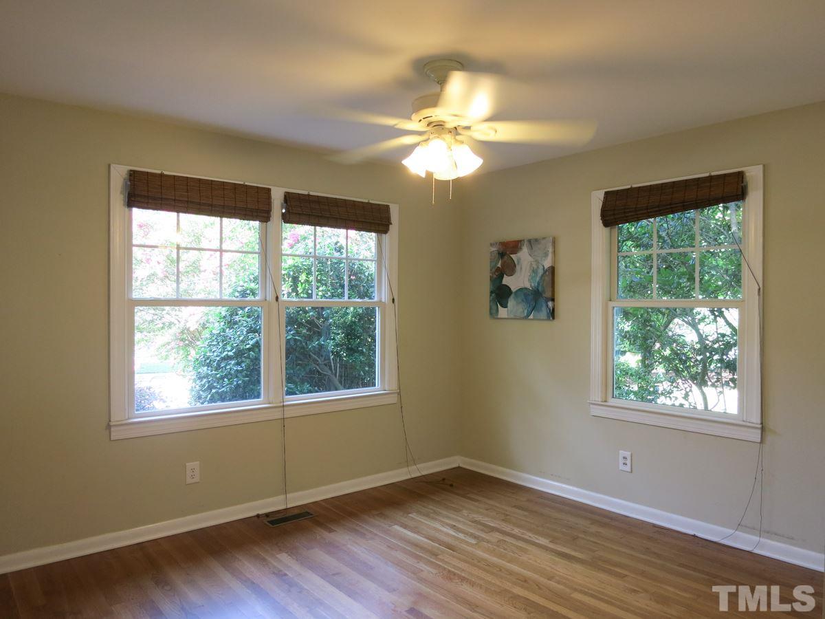704 Currituck Drive Raleigh, NC 27609 - Photo 18 of 25 a view of an empty room with wooden floor and a window