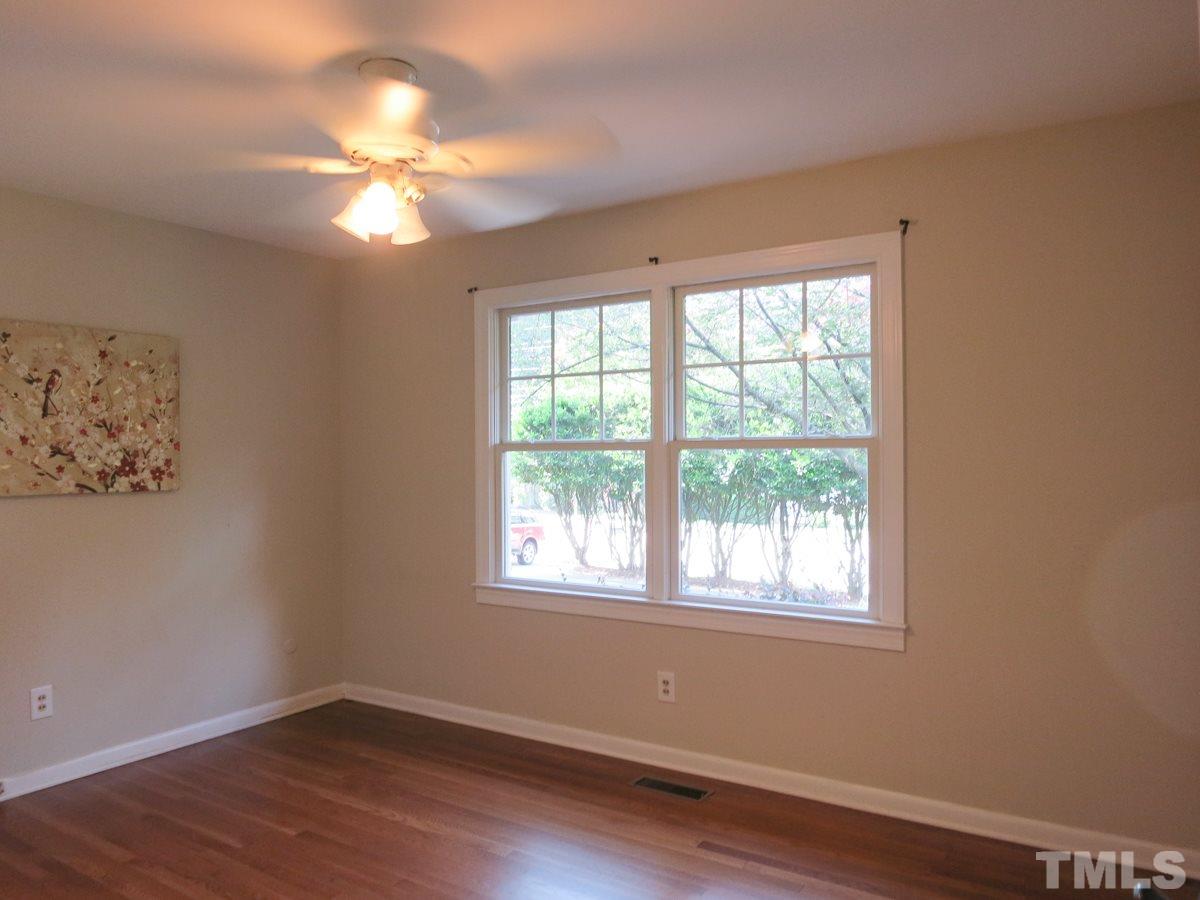 704 Currituck Drive Raleigh, NC 27609 - Photo 19 of 25 a view of empty room with wooden floor and fan