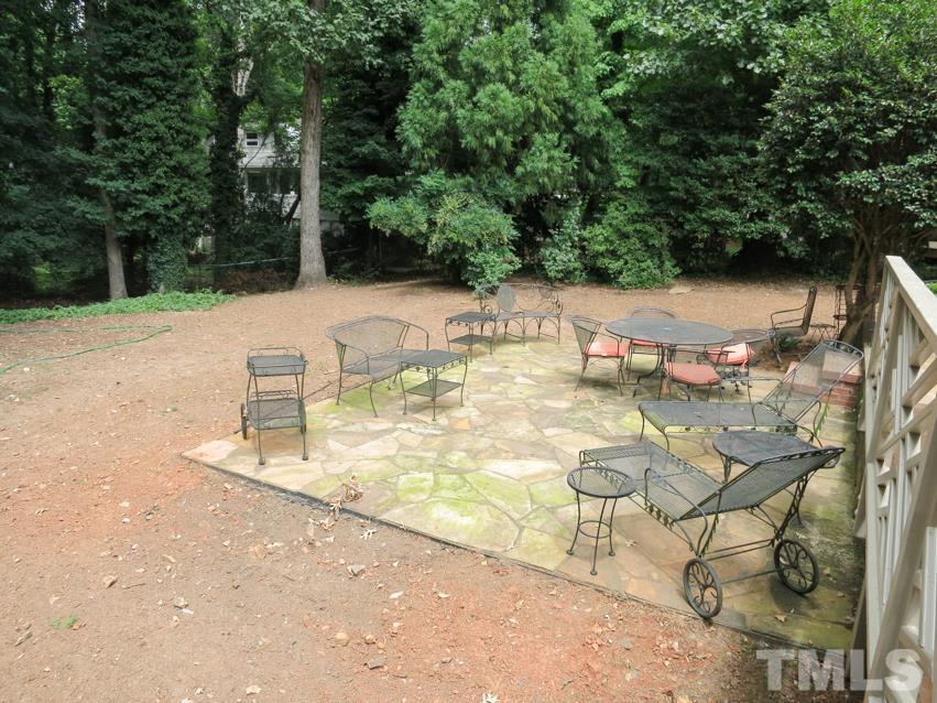 704 Currituck Drive Raleigh, NC 27609 - Photo 23 of 25 a view of backyard with a table and chairs