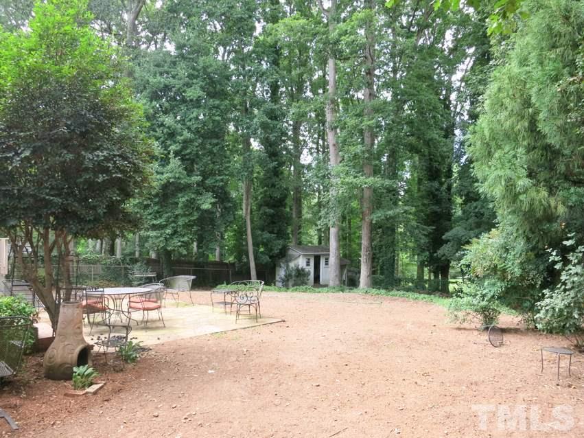 704 Currituck Drive Raleigh, NC 27609 - Photo 24 of 25 a view of outdoor space with deck and trees