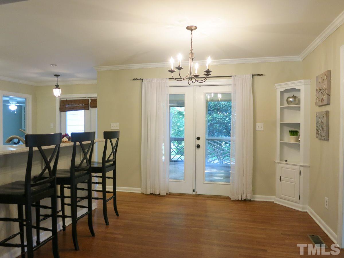 704 Currituck Drive Raleigh, NC 27609 - Photo 5 of 25 a view of a dining room with furniture and wooden floor