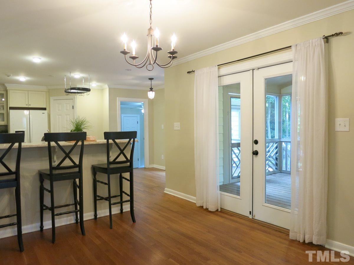 704 Currituck Drive Raleigh, NC 27609 - Photo 6 of 25 a view of a dining room with furniture and wooden floor