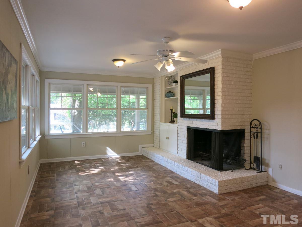 704 Currituck Drive Raleigh, NC 27609 - Photo 7 of 25 a living room with furniture and a fireplace