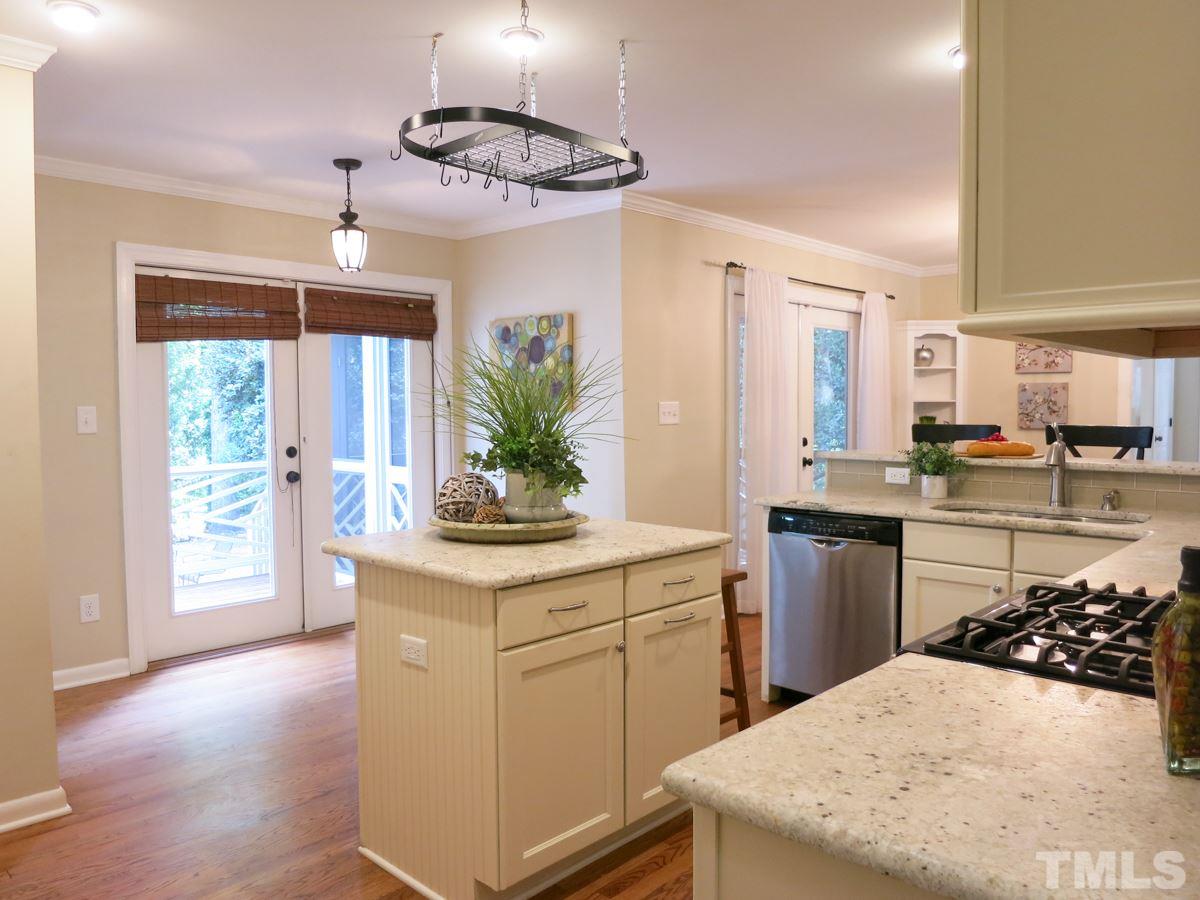 704 Currituck Drive Raleigh, NC 27609 - Photo 9 of 25 a kitchen with a sink a counter top space and stainless steel appliances