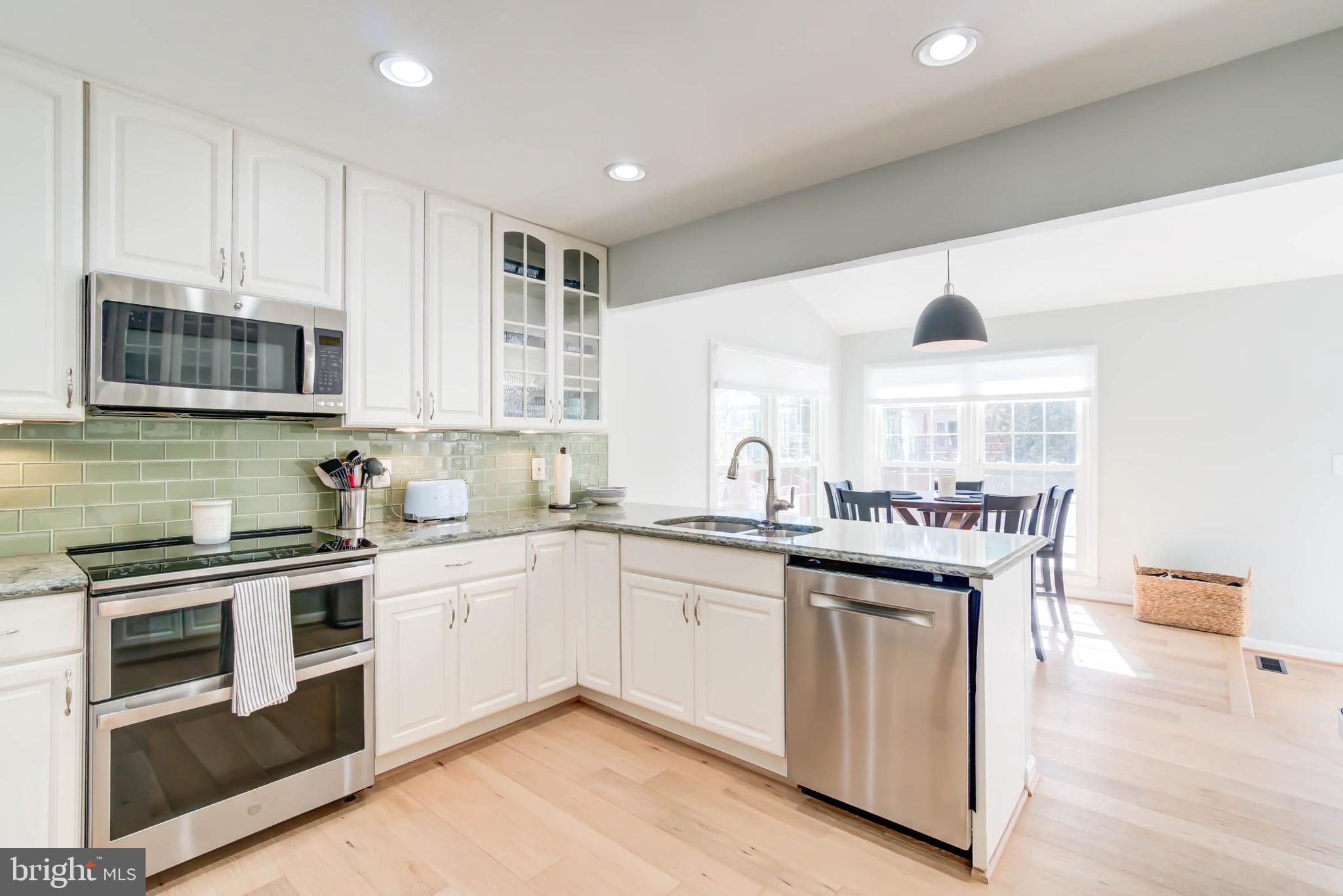 6617 Morning Ride Circle Alexandria, VA 22315 - Photo 16 of 51 a kitchen with stainless steel appliances granite countertop a sink and stove top oven