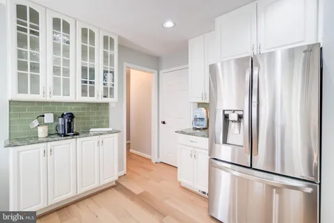 a kitchen with stainless steel appliances a refrigerator and cabinets
