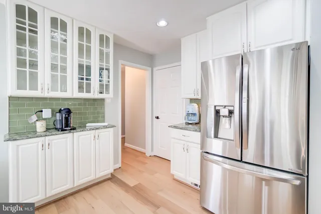 a kitchen with stainless steel appliances a refrigerator and cabinets