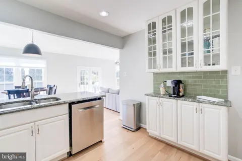 a kitchen with stainless steel appliances granite countertop a sink and cabinets