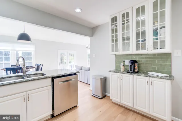 a kitchen with stainless steel appliances granite countertop a sink and cabinets