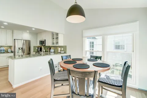 a kitchen with a dining table and chairs
