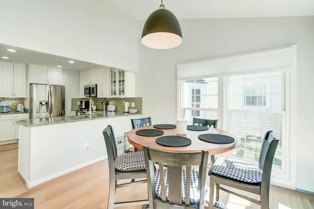 a kitchen with a dining table and chairs
