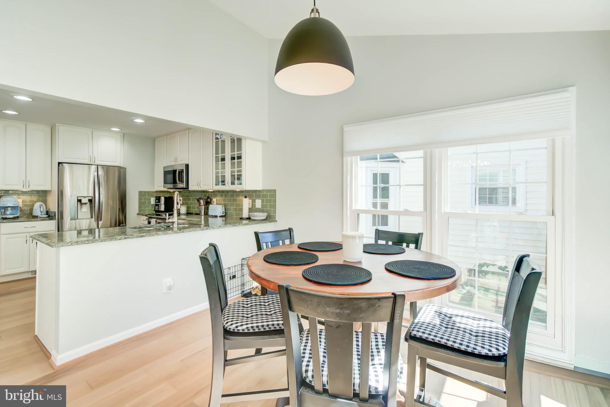 6617 Morning Ride Circle Alexandria, VA 22315 - Photo 21 of 51 a kitchen with a dining table and chairs
