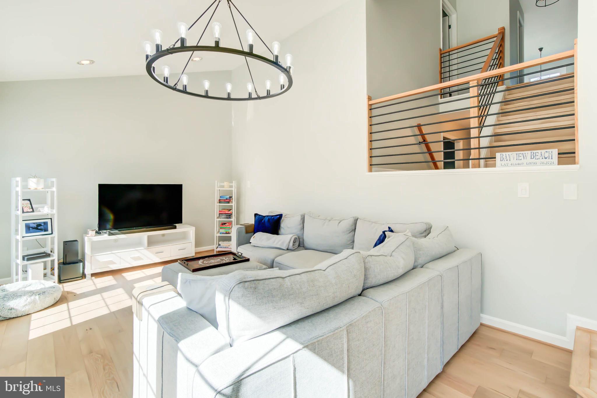 6617 Morning Ride Circle Alexandria, VA 22315 - Photo 24 of 51 a living room with furniture and a flat screen tv
