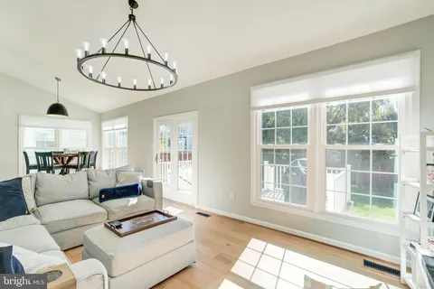 a living room with furniture a window and a chandelier