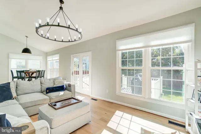 a living room with furniture a window and a chandelier