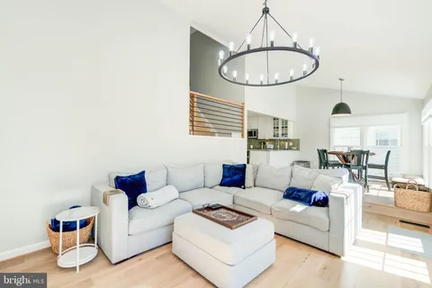 a living room with furniture a table and a chandelier