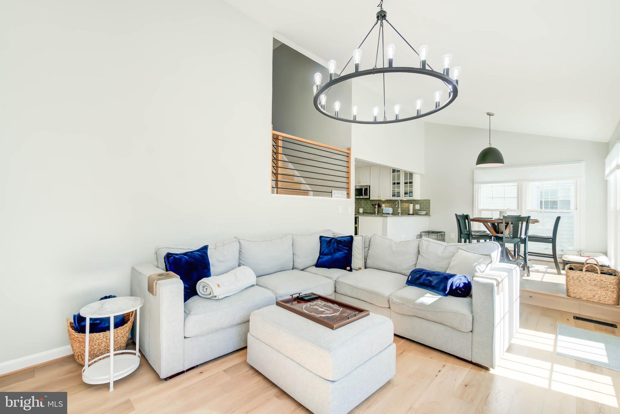 6617 Morning Ride Circle Alexandria, VA 22315 - Photo 26 of 51 a living room with furniture a table and a chandelier