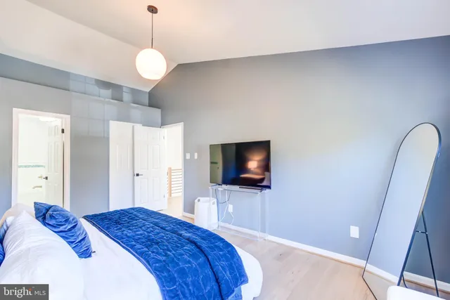 a bedroom with a bed and a flat screen tv