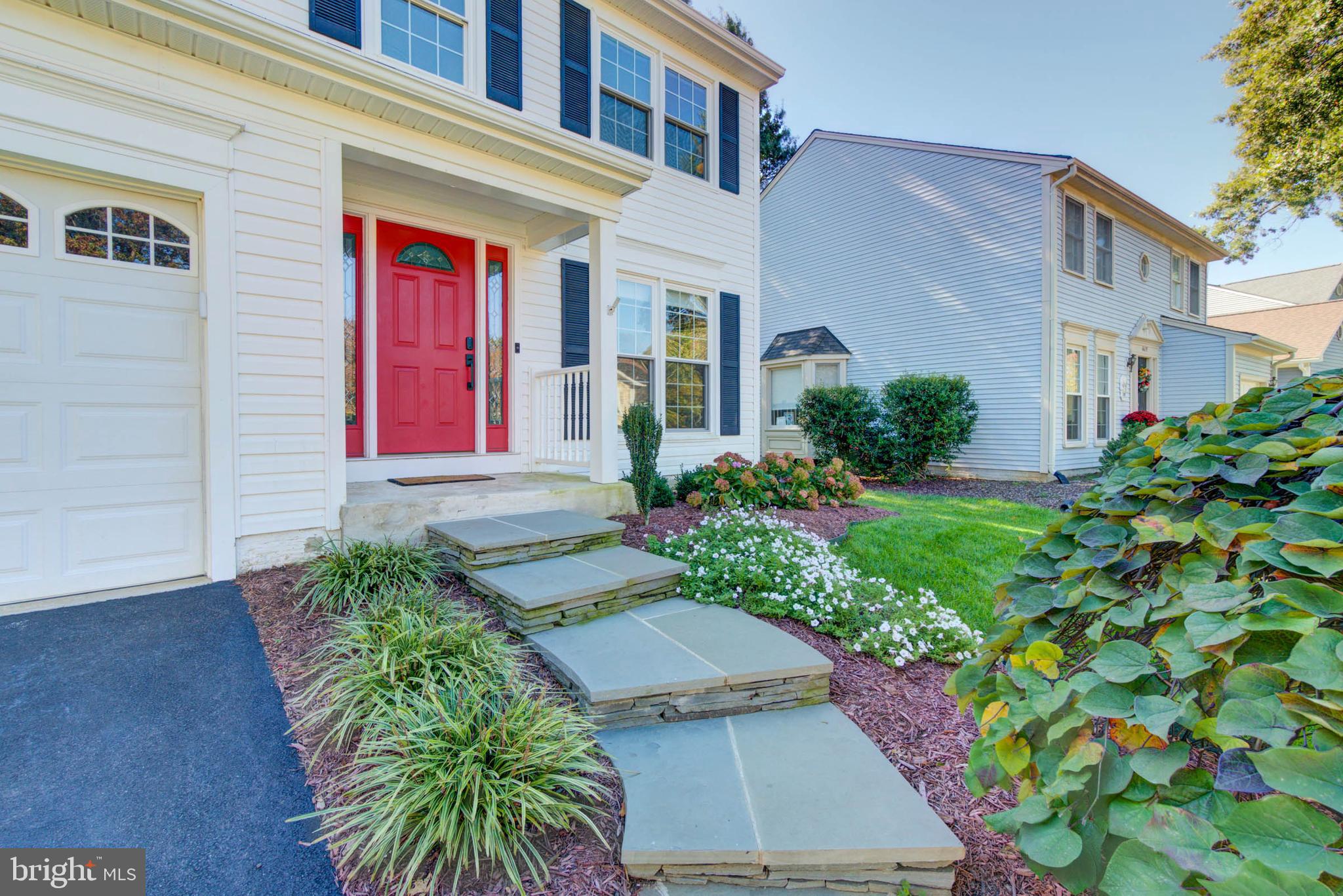 6617 Morning Ride Circle Alexandria, VA 22315 - Photo 6 of 51 a front view of a house with garden